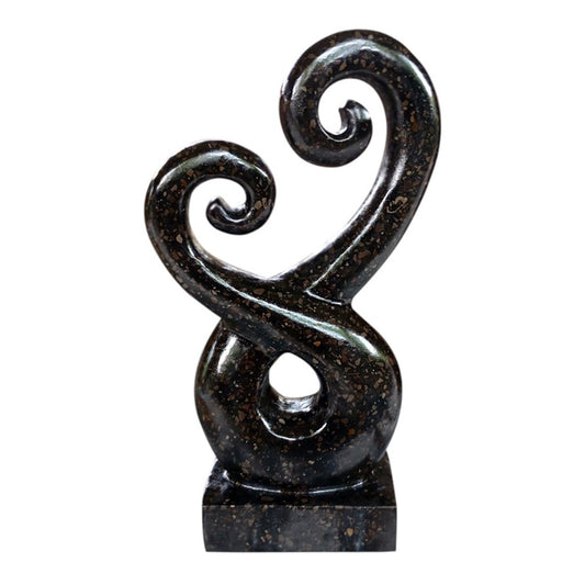 Terrazzo Koru Entwined Black 25cm 
H:25 x W:17 x D:10 cm - Terrazzo Black Koru. Available in black or white. Comes wrapped in cardboard. It is recommended to apply a stone sealer every 9-12 months to protect from the elements. The Koru (Maori for 'loop') is a spiral shape based on the unfurling silver fern frond of the ponga plant. The Maori Koru design carries a spiritual meaning, one of peace, tranquility, positive change and new beginnings.
SKU: WT8595A-B