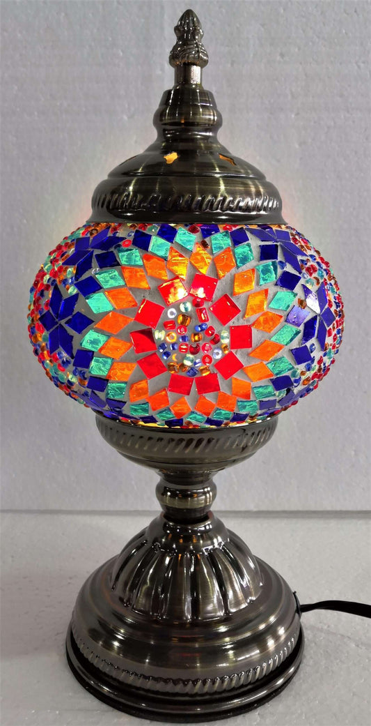 Mosaic lamp with colorful glass pieces on a gray background