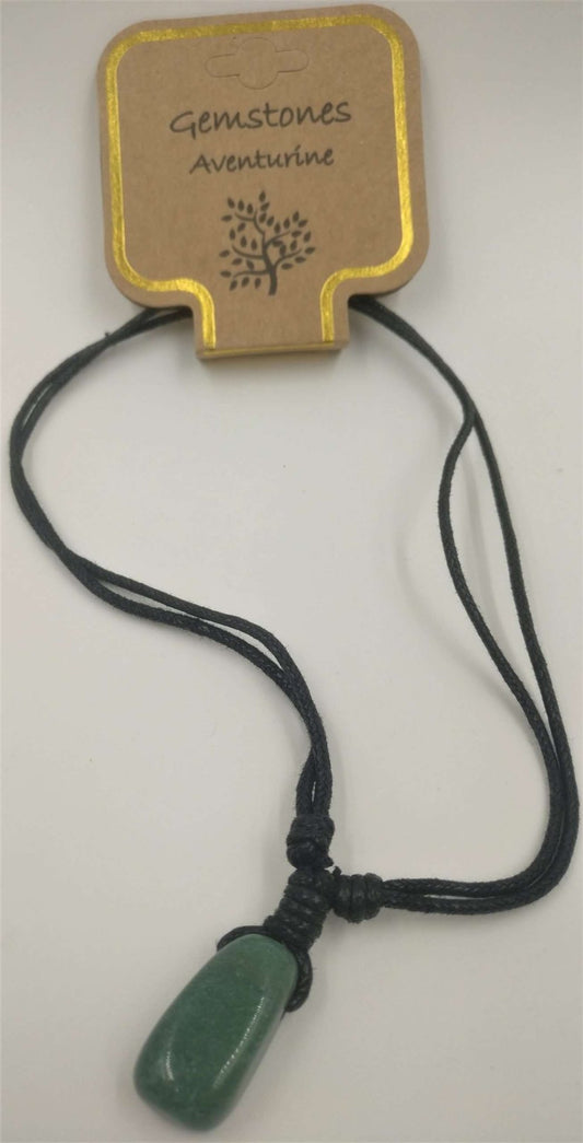 A green aventurine stone pendant attached to a beige card with the text 'GEMSTONES ADVENTURINE' and a decorative snowflake design at the top. A black cord connects the pendant to the card.