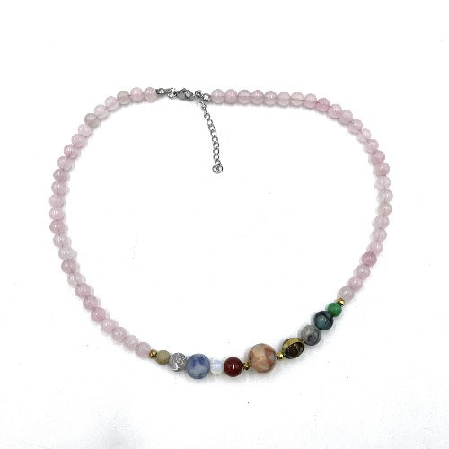 A pink rose quartz beaded necklace with a silver chain and various colored gemstone accents.