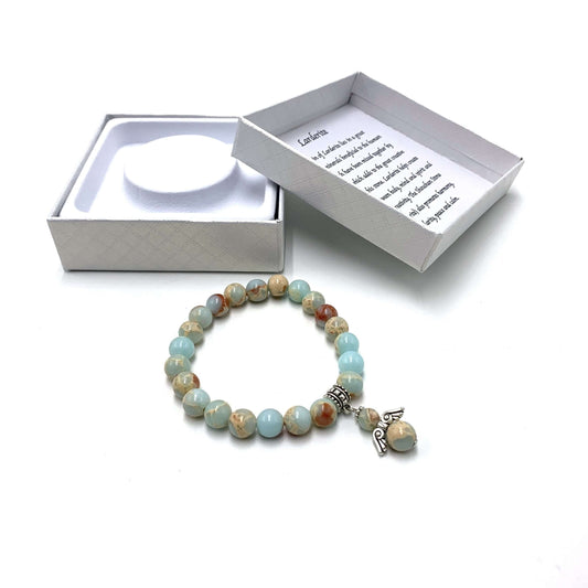Multicolored beaded bracelet with a charm on a white background