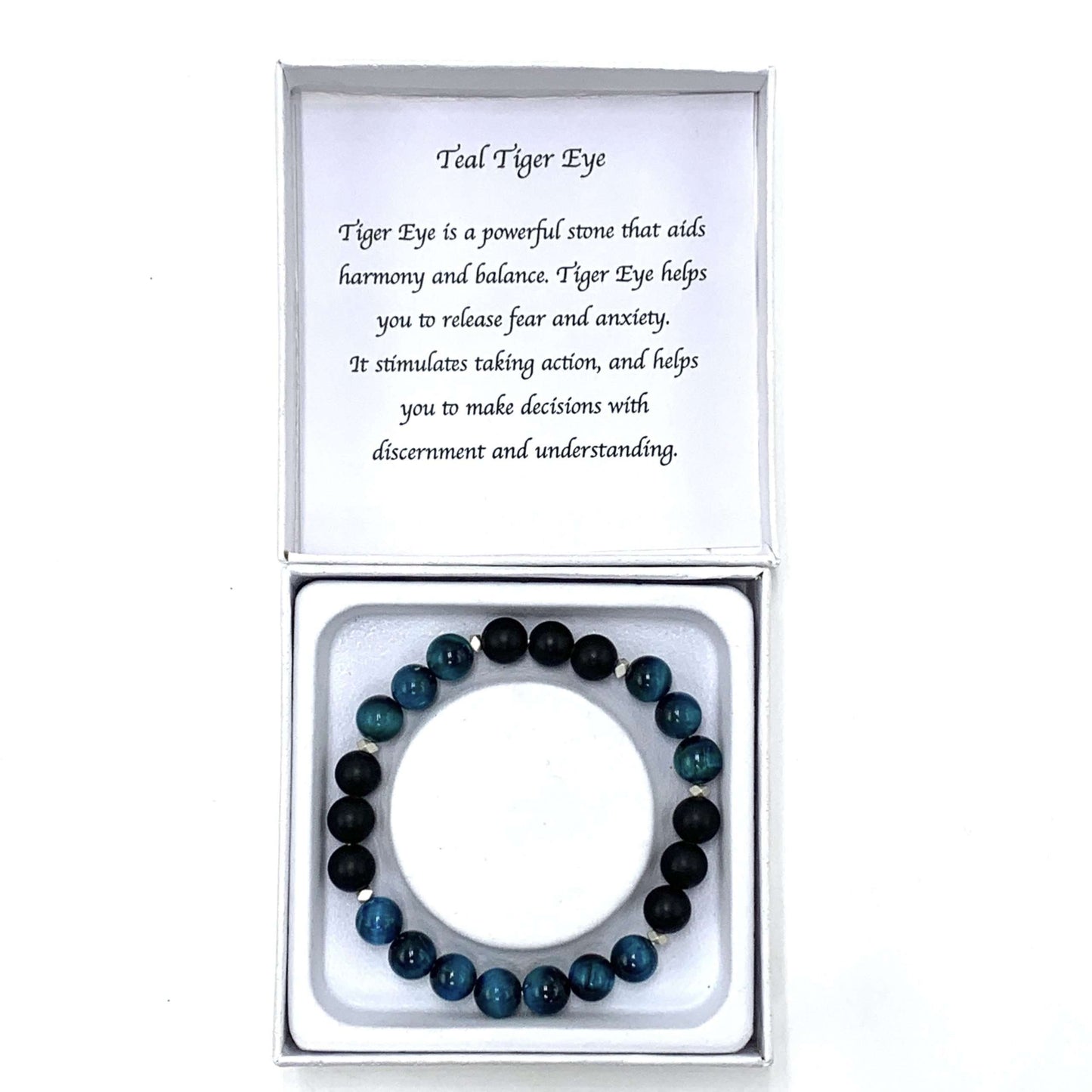 Teal and black beaded bracelet in a box with a card explaining the stone's properties.