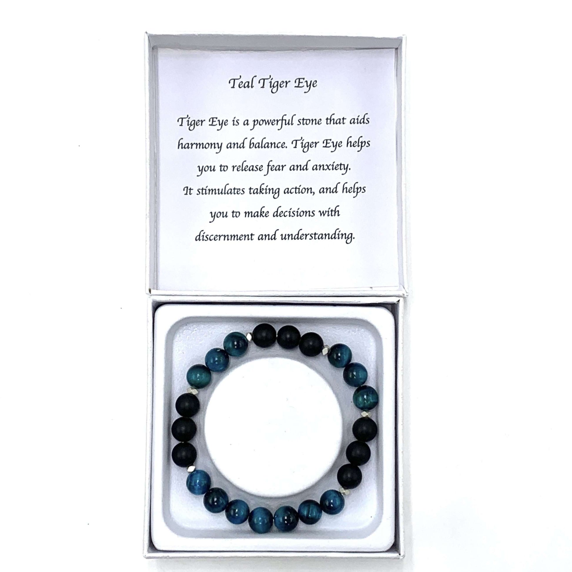 Teal and black beaded bracelet in a box with a card explaining the stone's properties.