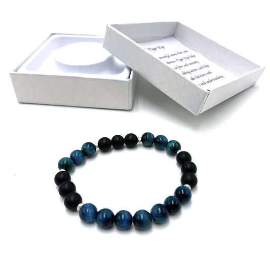 Blue beaded bracelet on a white background with an open box displaying text.
