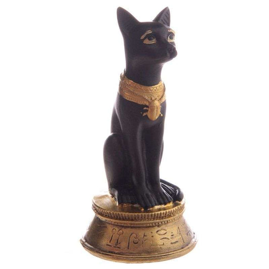 Black cat figurine with gold accents on a white background