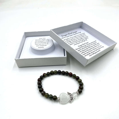 Beaded bracelet with a heart charm on a white background, featuring a branded box.
