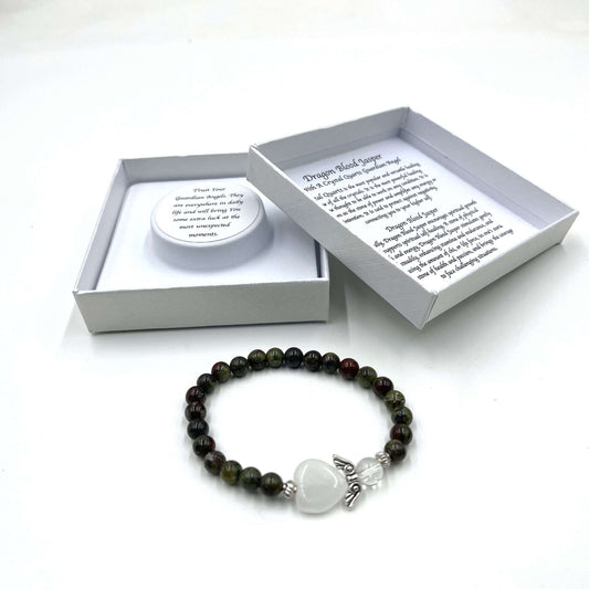 Beaded bracelet with a heart charm on a white background, featuring a branded box.