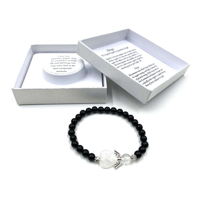 Black beaded bracelet with a heart charm on a white background