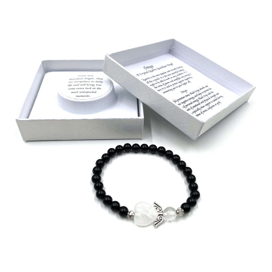 Black beaded bracelet with a heart charm on a white background