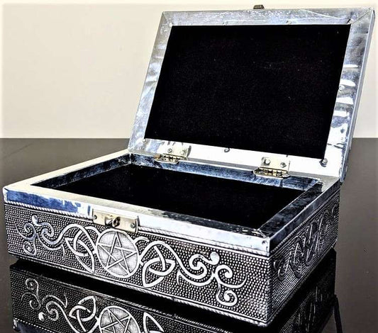 Decorative jewelry box with pentacle design on a reflective surface