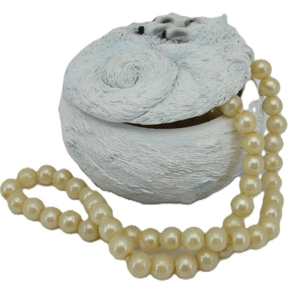 Decorative stone with a pearl necklace on a white background