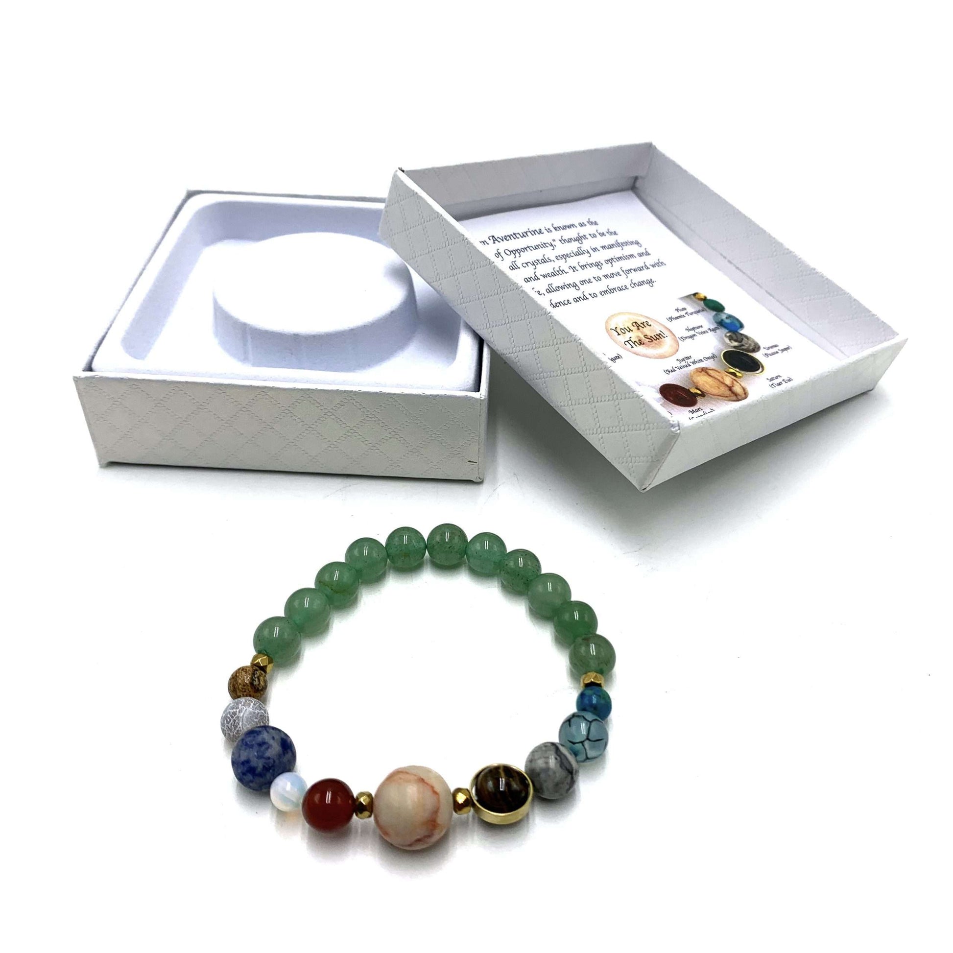 Multicolored beaded bracelet with a white box containing a bracelet and card on a white background