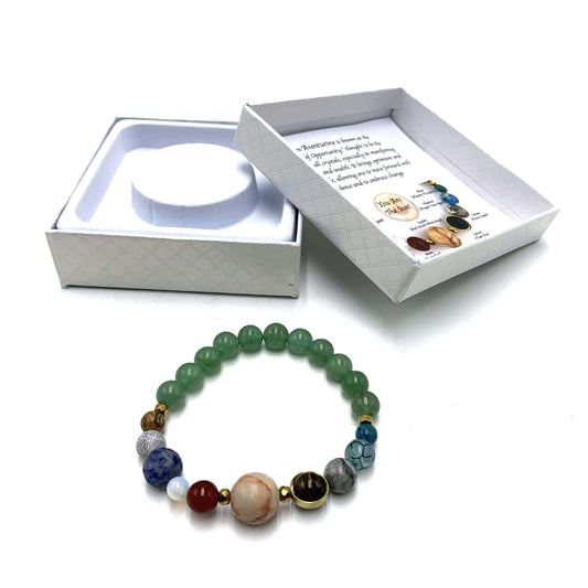 Multicolored beaded bracelet with a white box containing a bracelet and card on a white background
