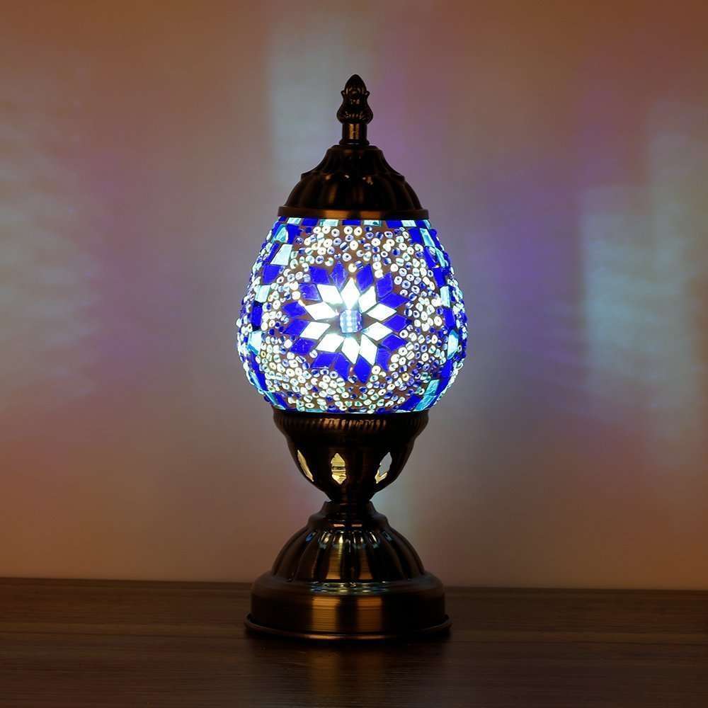Decorative table lamp with mosaic design on a wooden surface