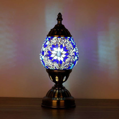 Decorative table lamp with mosaic design on a wooden surface