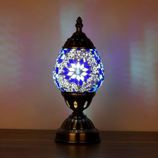 Decorative table lamp with mosaic design on a wooden surface
