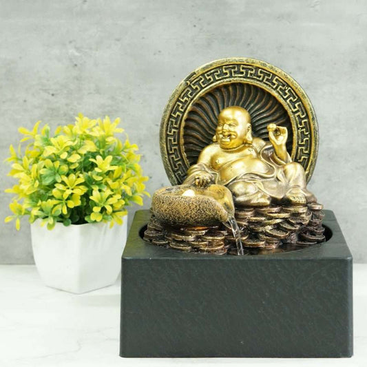 Gold Buddha statue on a pedestal with decorative elements against a gray background