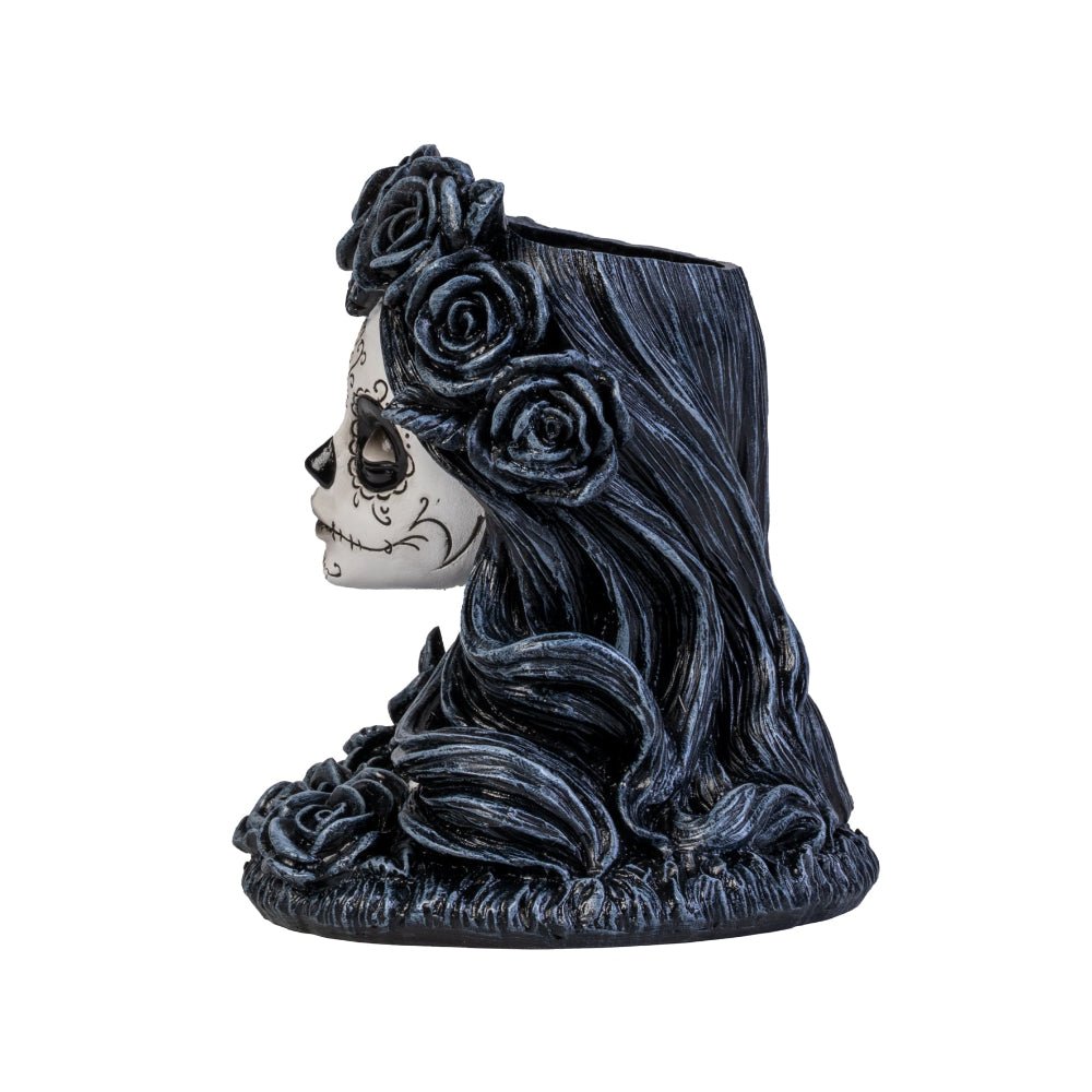 Meet the Dead Beautiful Tealight Holder, your new gothic table companion! Crafted in the likeness of a sweet yet spooky sugar skull maiden, this candle holder is ready to haunt your home with a delightful touch of mystery and charm. Complete with intricately sculpted roses and Day of the Dead face art, she is as perfect for a chilling dinner party as she is for turning any ordinary night into an enchanting spectacle!  1st Stop, Marshall's Health Shop, Gift Shop!