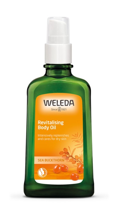 Weleda revitalizing body oil bottle on a white background