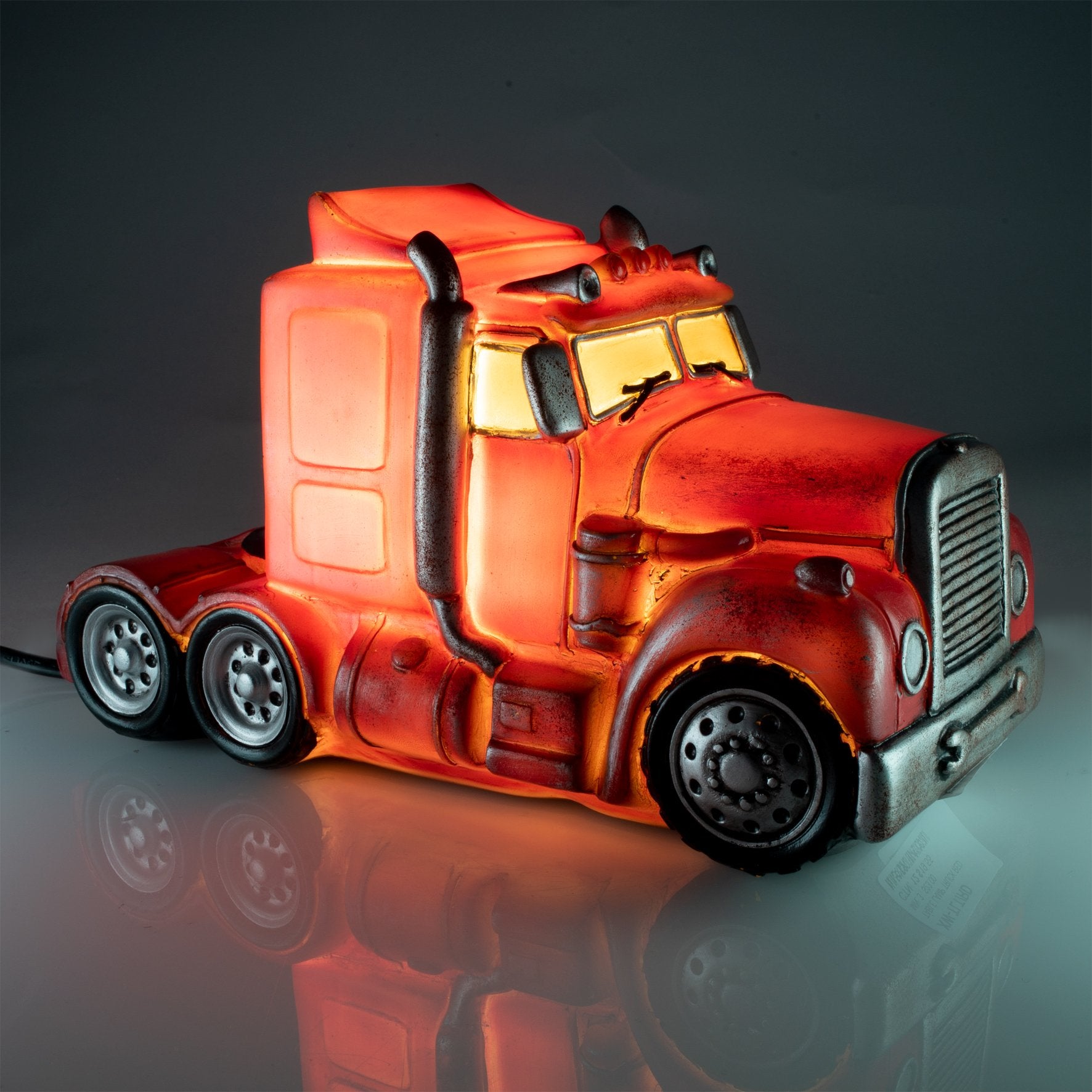 Red Metal Look Truck Table Lamp Classic semi trailer truck with metal look exterior and rust detailing Combination of polyresin and fibreglass makes for a smooth and shiny surface that gives off a soft glow when lit