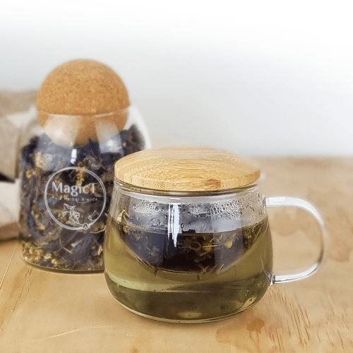 MagicT - Infuser Mug (Bamboo Lid) 300ml 1st Stop, Marshall's Health Shop!  This infuser mug with a Bamboo wooden lid looks elegant, unique and handy. It is ideal to see the colour of your herbal tea. The mug is made of high borosilicate glass and the wooden lid allows to keep the heat and aroma of the tea inside the cup.