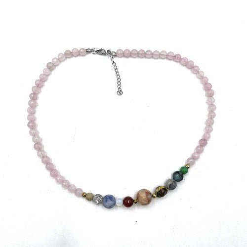 A pink rose quartz beaded necklace with a silver chain and various colored gemstone accents.